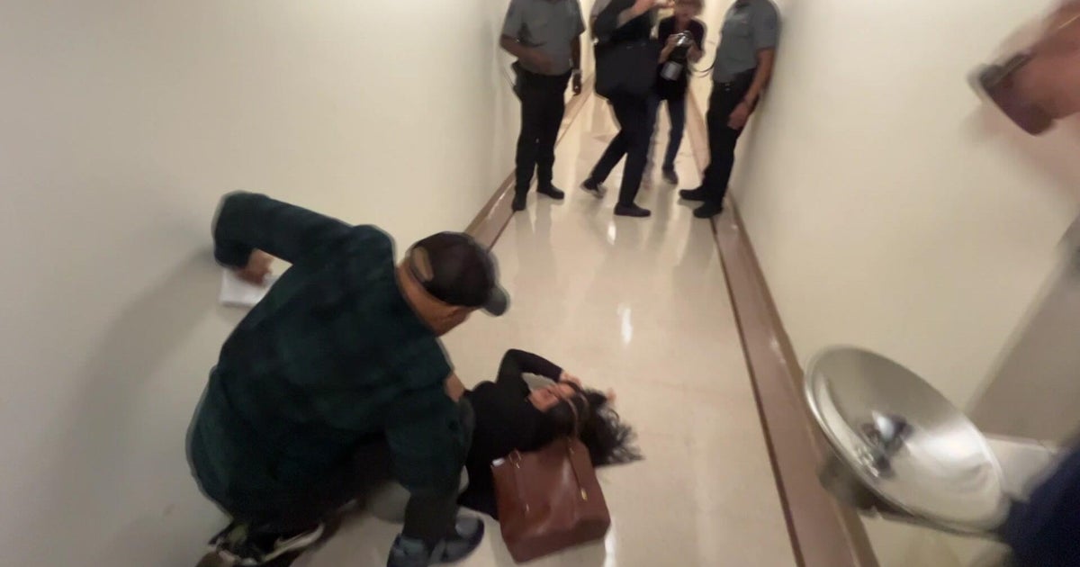 ICE officer seen on video pushing woman to ground has returned to duty - CBS News