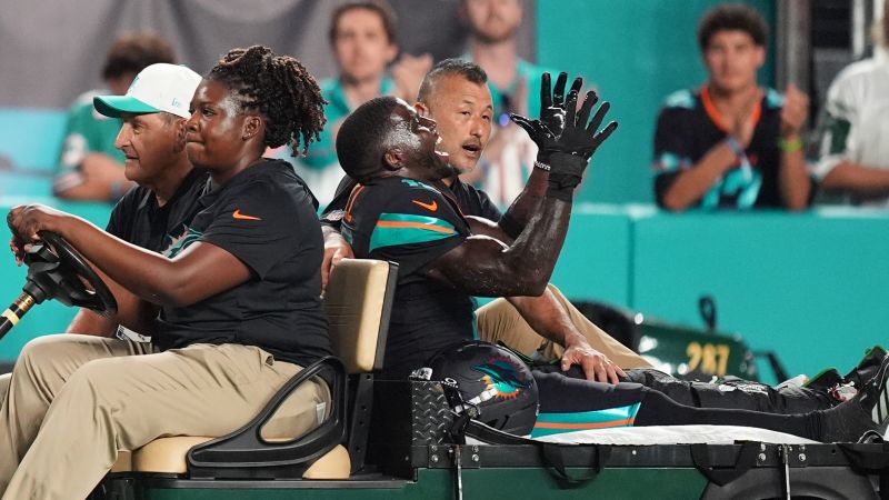 Dolphins’ Tyreek Hill carted off field and taken to hospital with dislocated left knee | CNN