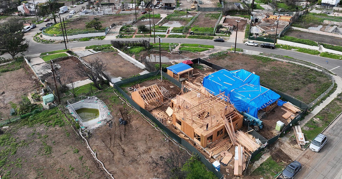 A city rises again from the ashes – but will it be strong enough? - CBS News