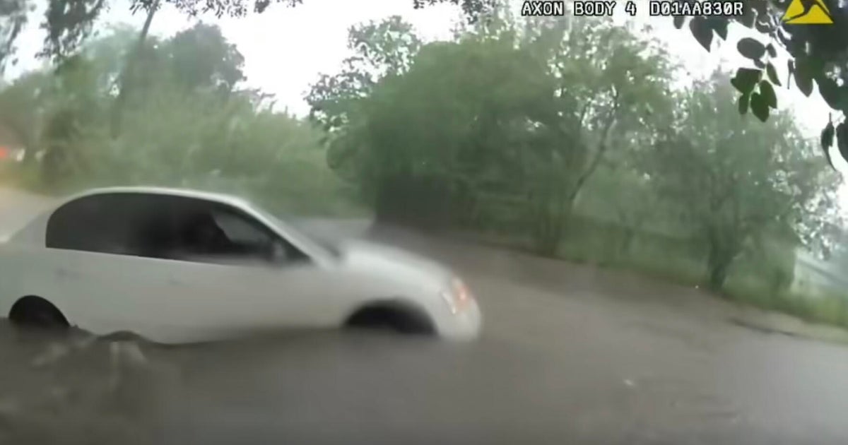 Video shows infant being rescued from car trapped in Texas floodwaters - CBS News