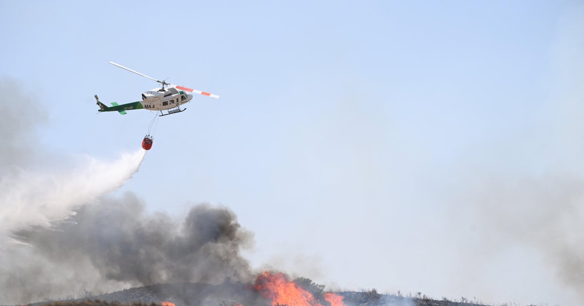 Hundreds of firefighters in Spain battle deadly wildfires that killed at least 12 fleeing flames - CBS News